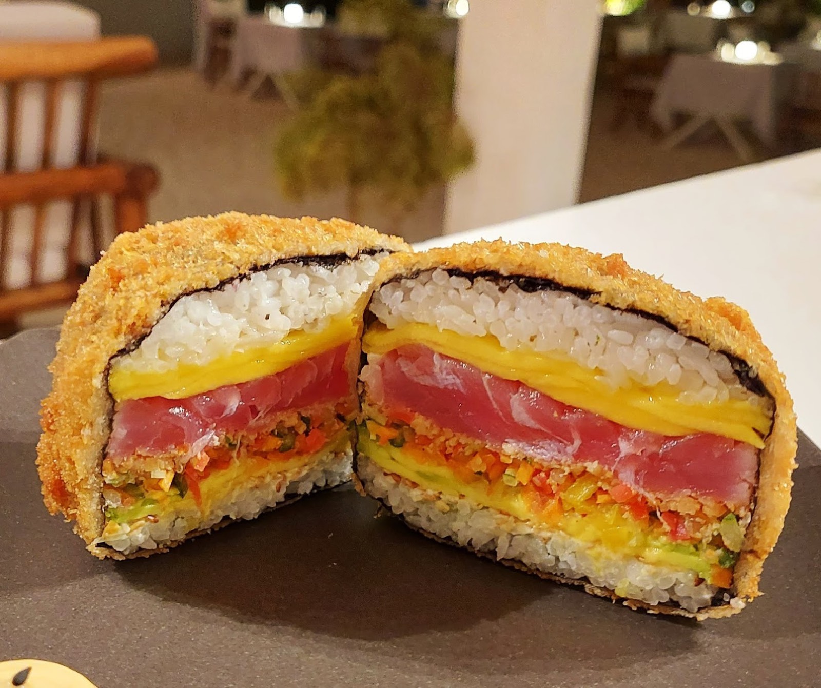 Cross-section of a crispy panko-fried roll with tuna, tamago and vegetables