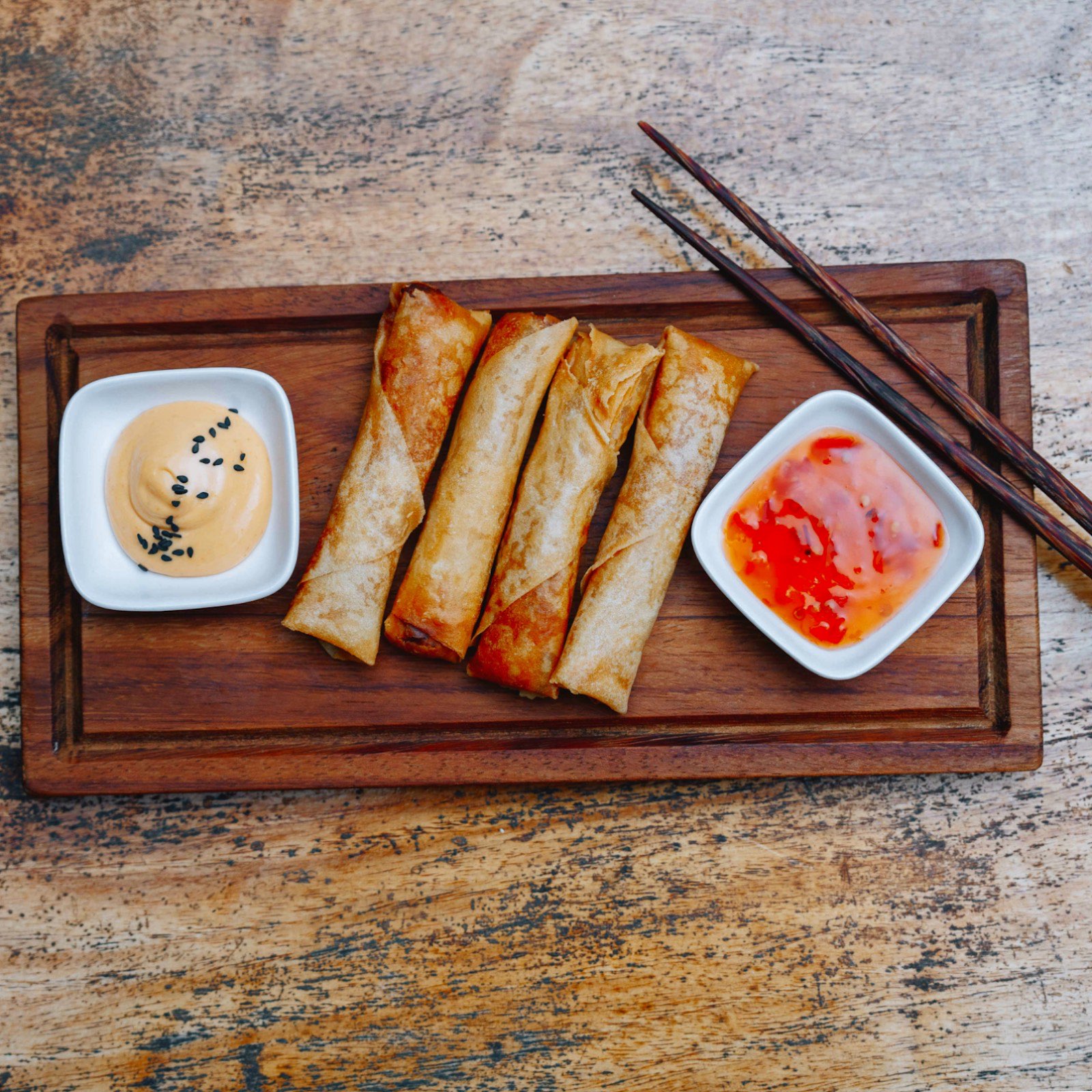 Golden spring rolls with spicy mayo and sweet chili dipping sauces